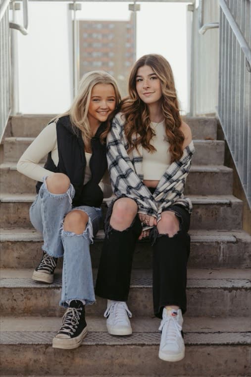 Two friends sitting together on a set of stone steps