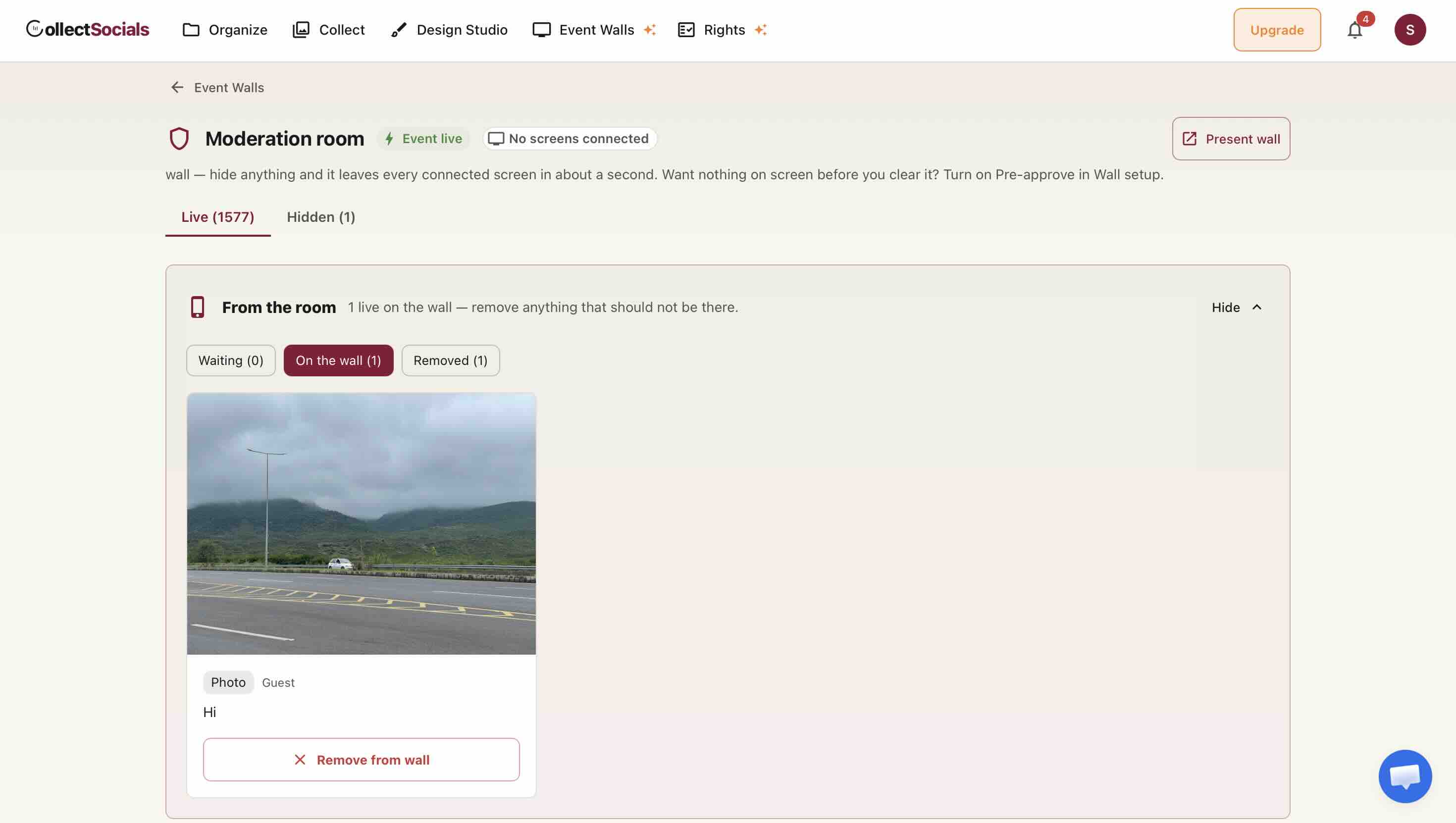 The CollectSocials moderation room during a live event, showing Live and Hidden tabs, a From the room panel with Waiting, On the wall and Removed filters, and a guest photo with a Remove from wall button